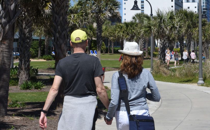 A man and a woman walking on Tours In Myrtle Beach.